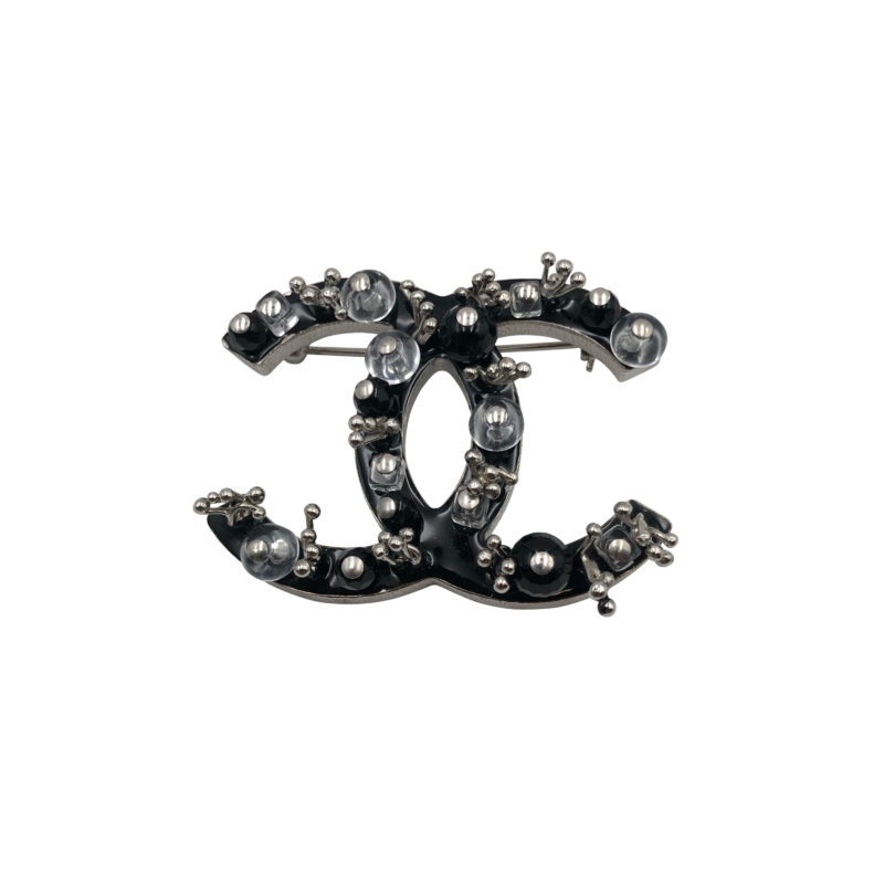Chanel 2010 brooch in black enamel with black jet and clear round