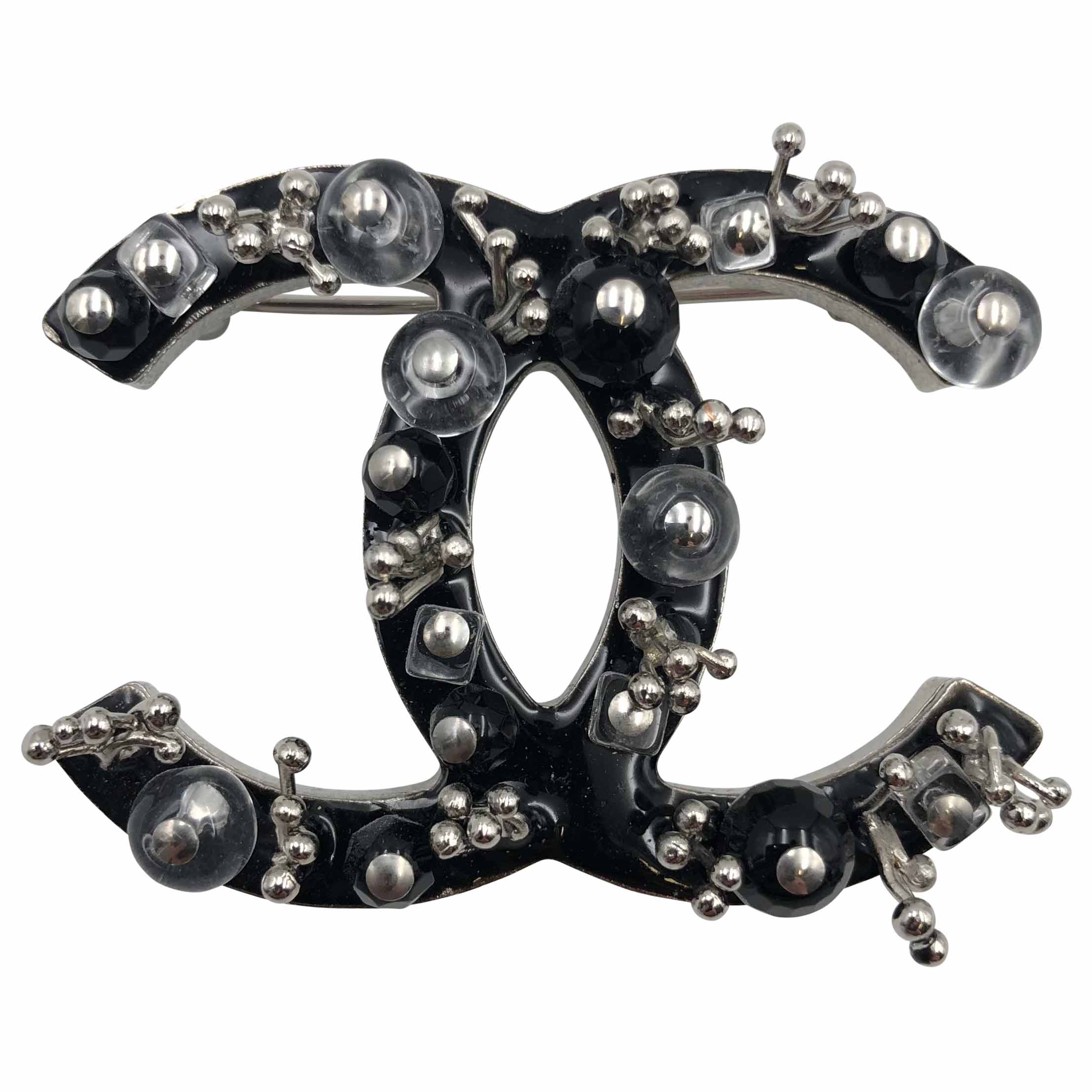 Chanel 2010 brooch in black enamel with black jet and clear round